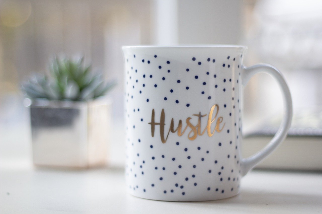 mug with hustle text on it