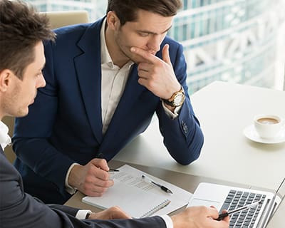 two businessmen looking at laptop